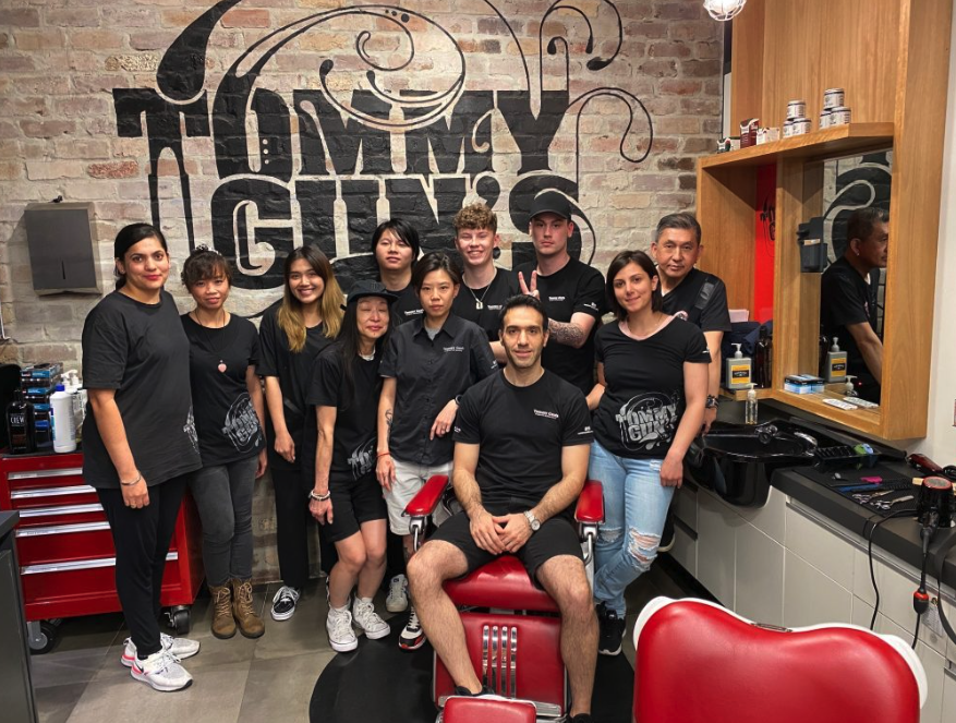 Team wearing matching printed black staff tees