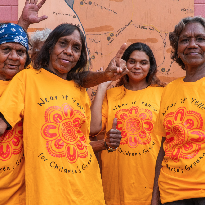 Three supporters wearing printed orange awareness tees