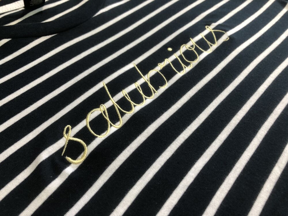 Close-up of gold embroidery stitched into a black garment